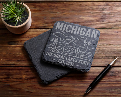 Slate coaster with Michigan map, lighthouse, deer, and text "The Great Lakes State Est. 1837".