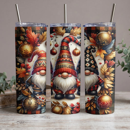 Three tumblers with gnomes, leaves, and ornaments on a wooden surface.