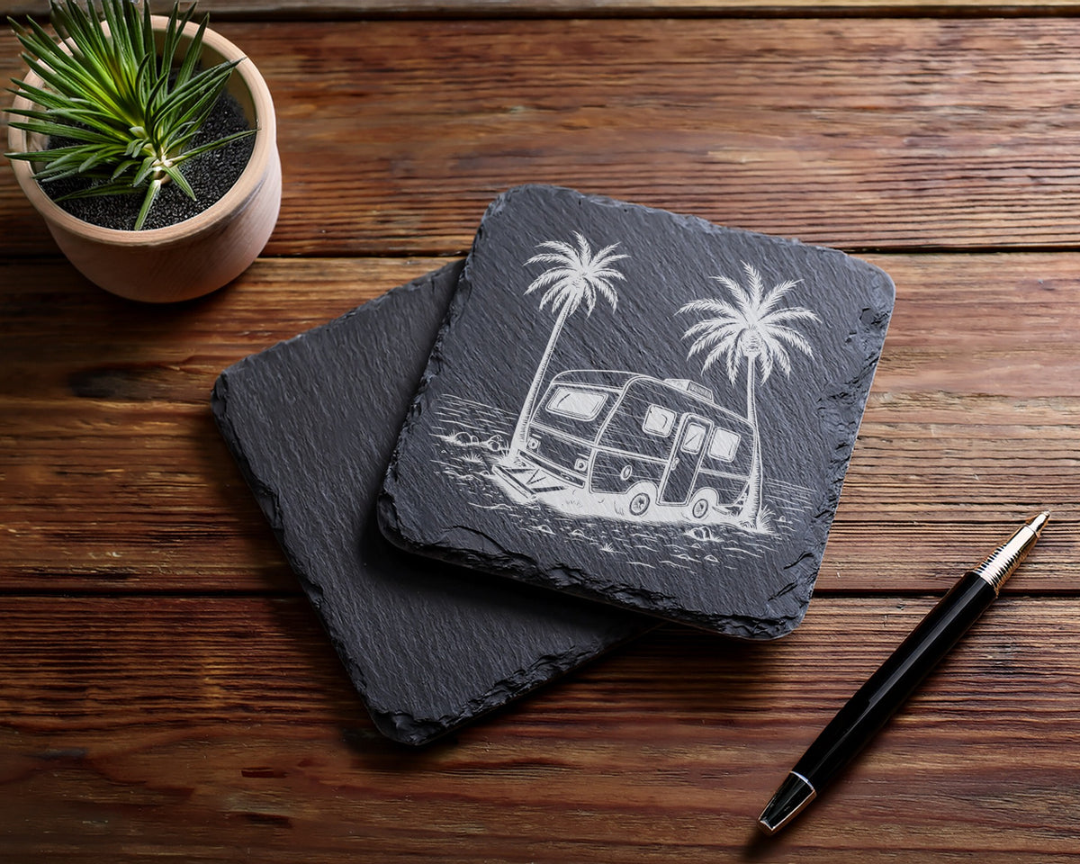 Two slate coasters, one engraved with a vintage camper and palm trees.