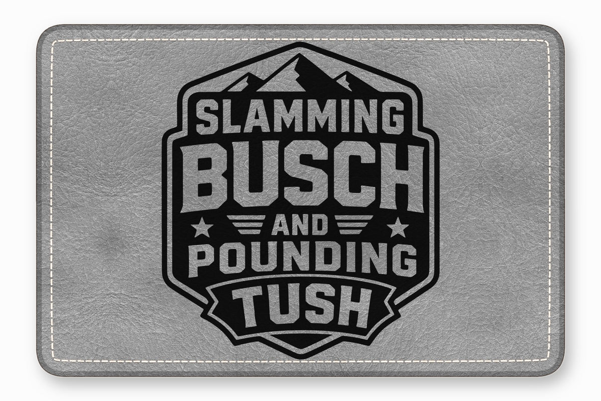 Gray faux leather patch featuring a black badge emblem with mountain graphics and text that reads Slamming Busch and Pounding Tush.