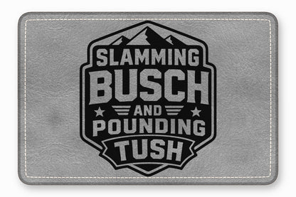 Gray faux leather patch featuring a black badge emblem with mountain graphics and text that reads Slamming Busch and Pounding Tush.