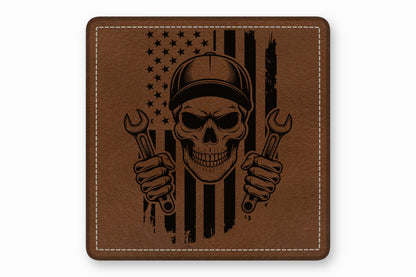 Brown leather patch featuring a black engraved mechanic skull wearing a cap and holding wrenches against an American flag.