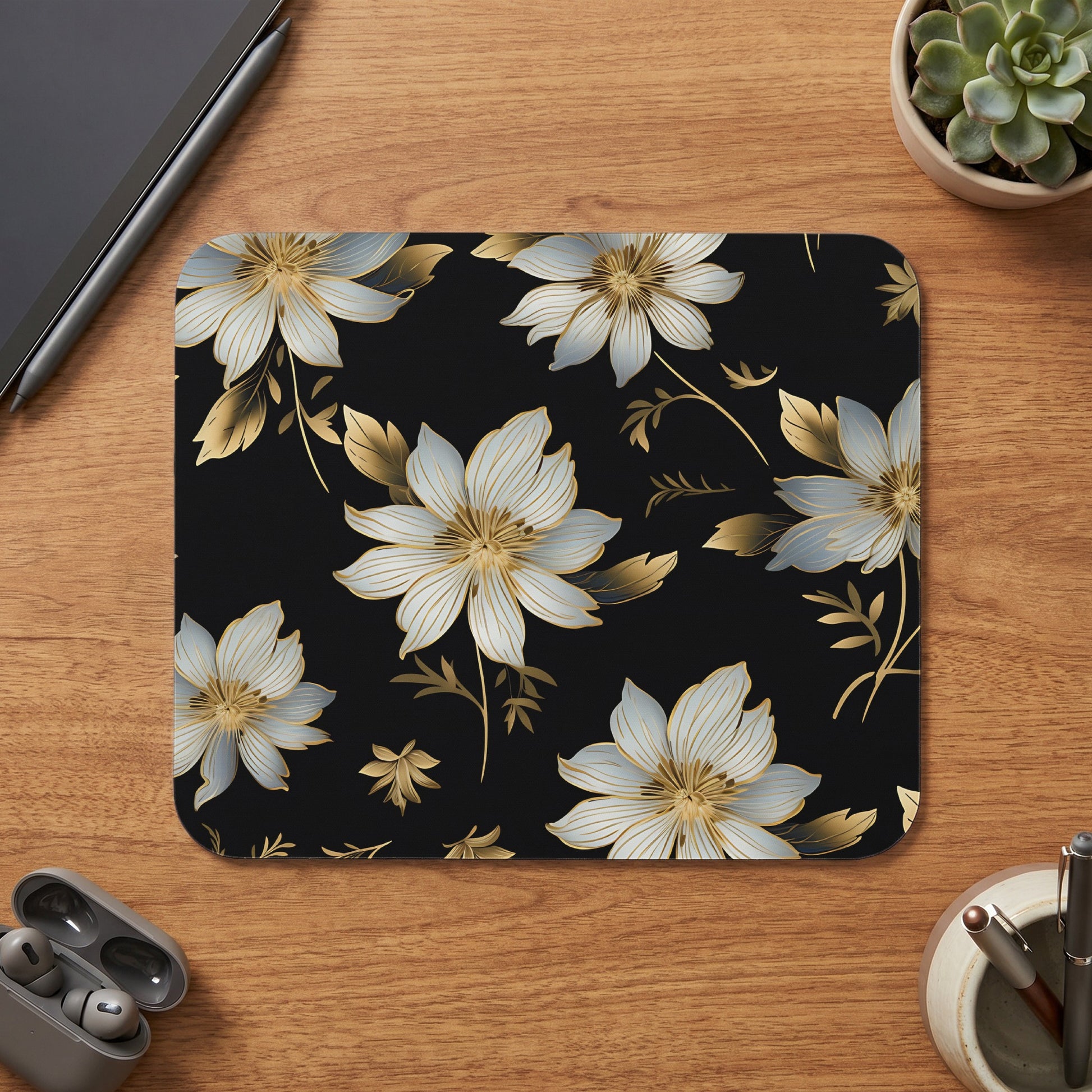 Mousepad with a black background and a gold and white floral pattern.