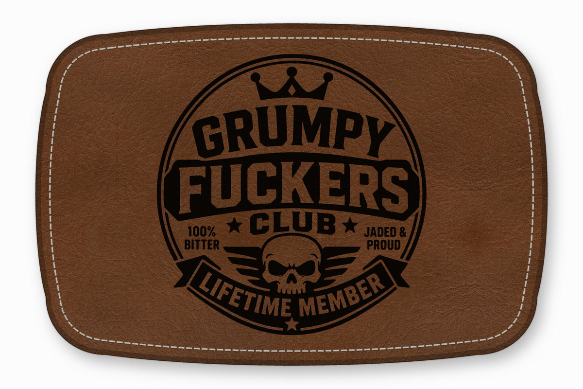 Brown leather patch with white stitched border and circular black text reading Grumpy Fuckers Club and Lifetime Member.