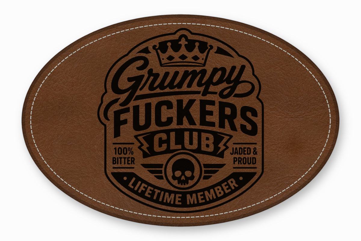 Brown oval leather patch featuring a black stamped Grumpy Fuckers Club logo with a skull and crown.