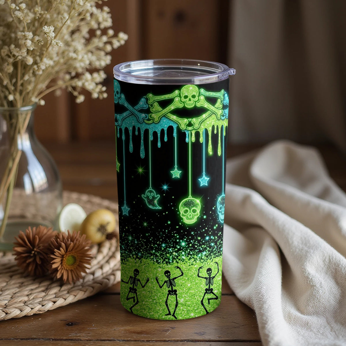 Tumbler with neon green and blue Halloween skeleton, skull, and ghost design.