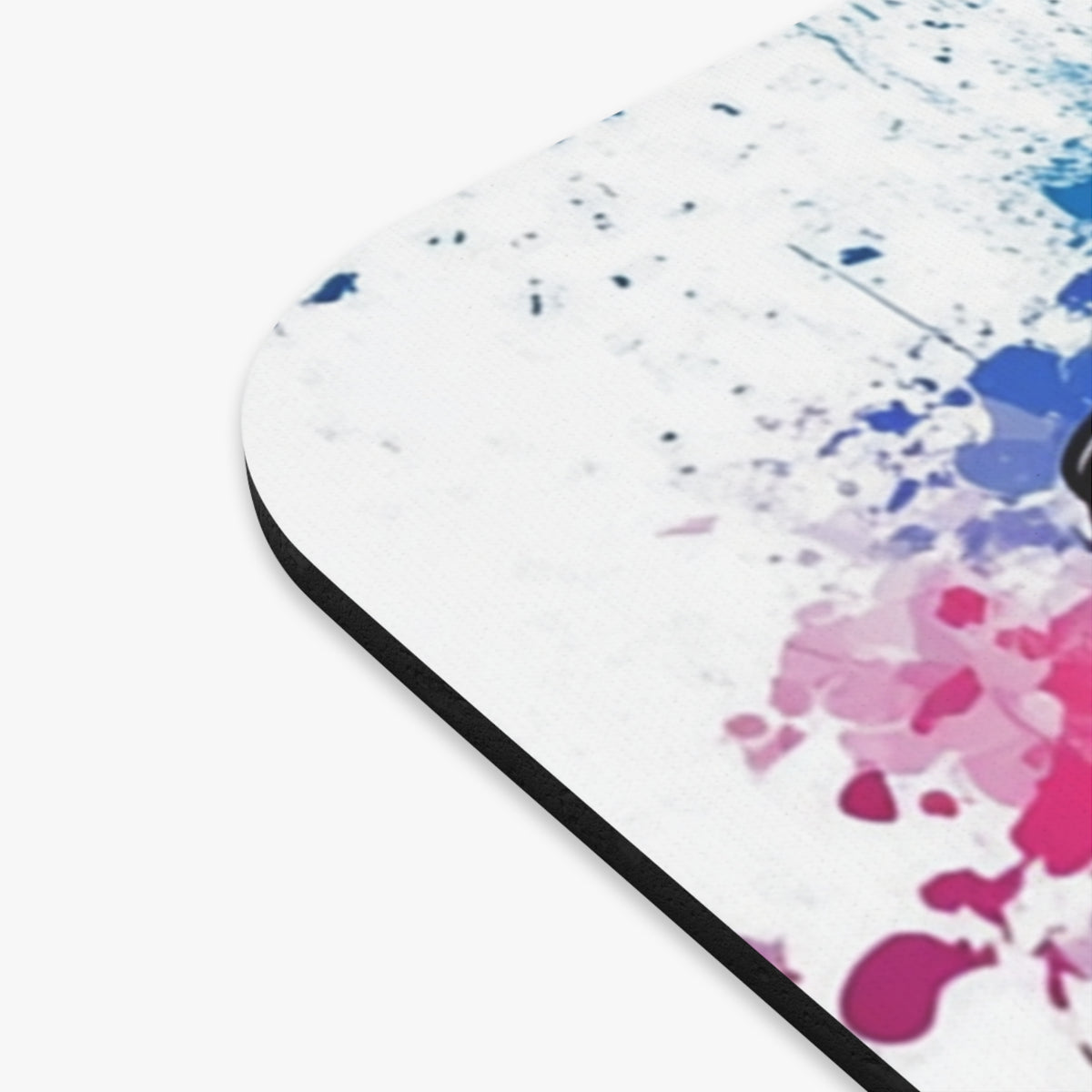 Mousepad with pink and blue paint splatters and black edge.