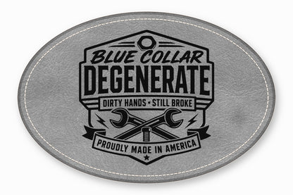 Oval gray leather patch with white stitched border and black printed graphic of crossed wrenches and text.
