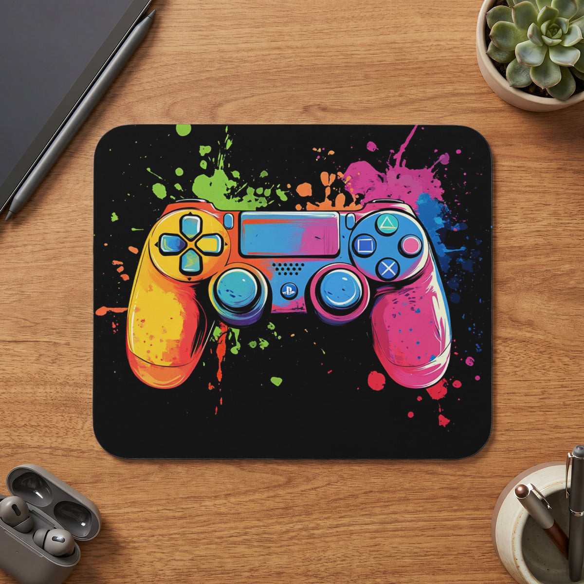 Video game controller with vibrant paint splatter design on a black background.