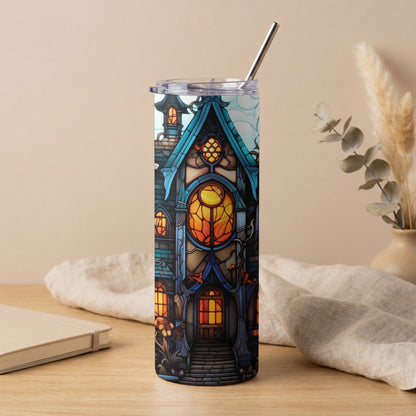 Tumbler with stained glass haunted house design, metal straw, and clear lid.