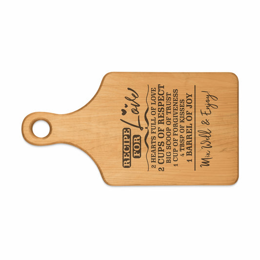 Wooden cutting board with engraved "Recipe for Love" and ingredients.