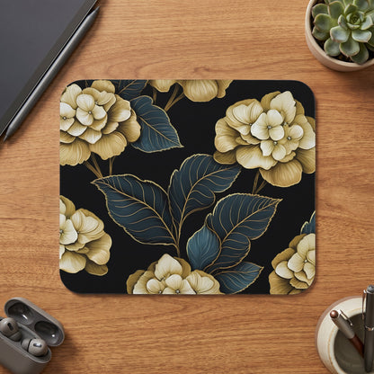 Mousepad with dark background and floral pattern of muted yellow hydrangeas and teal leaves.
