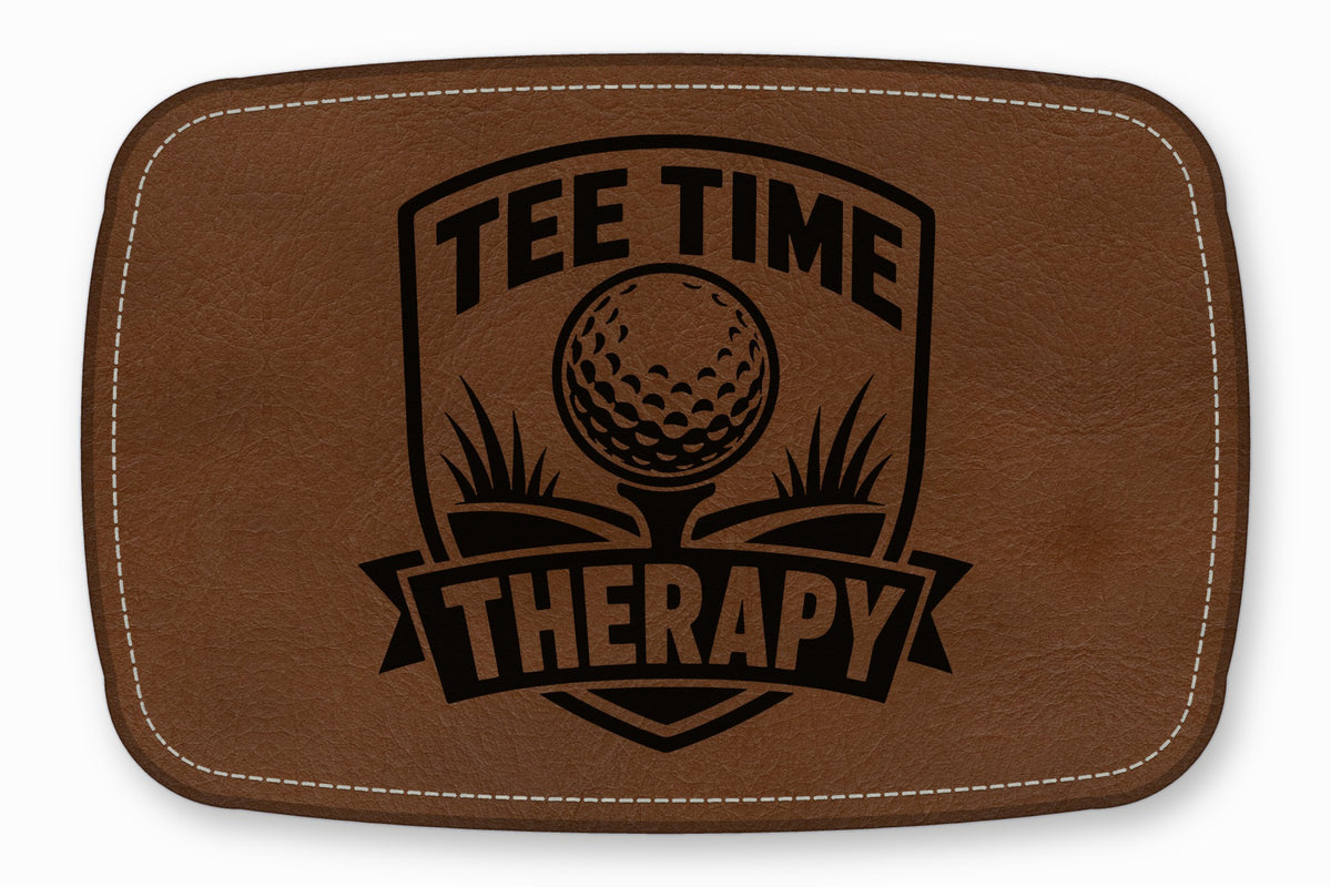 Brown leather patch with rounded corners, white stitching, and a black golf-themed design reading Tee Time Therapy.