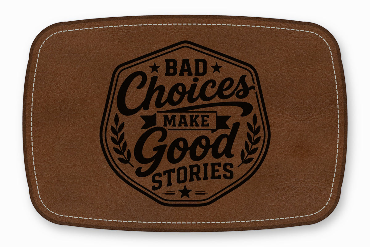 Brown leather patch with white stitching and the engraved text Bad Choices Make Good Stories.