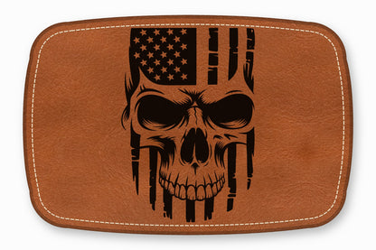 Brown rectangular leather patch with rounded corners, white stitching, and a black skull and American flag graphic.