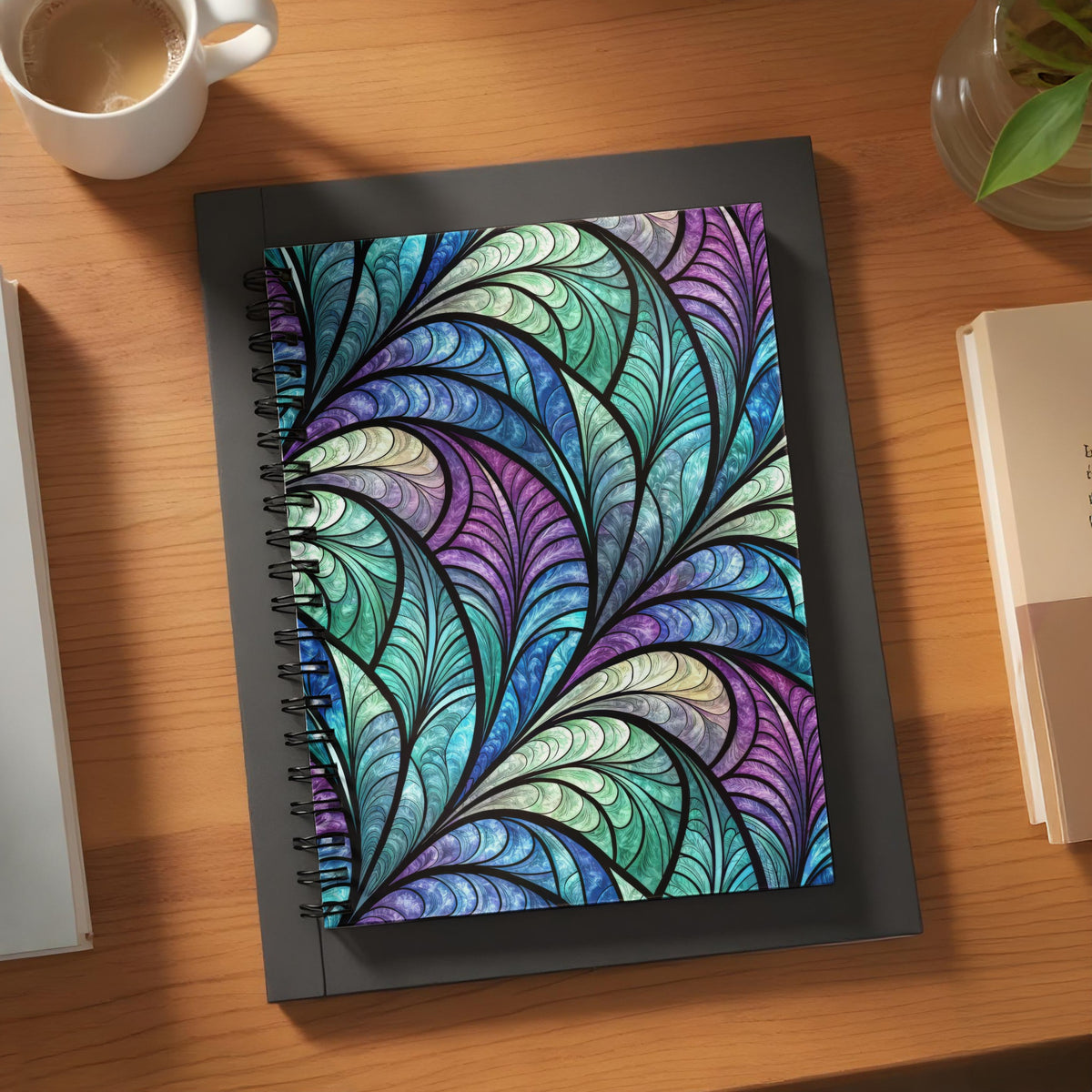 Spiral notebook with stained glass-inspired peacock feather pattern cover.