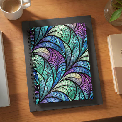 Spiral notebook with stained glass-inspired peacock feather pattern cover.