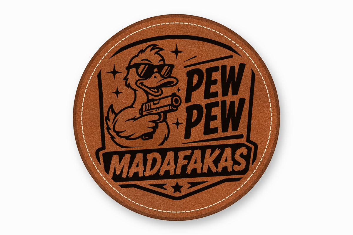 Round brown leather patch with white stitched border featuring a sunglasses-wearing duck holding a handgun and the text PEW PEW MADAFAKAS.