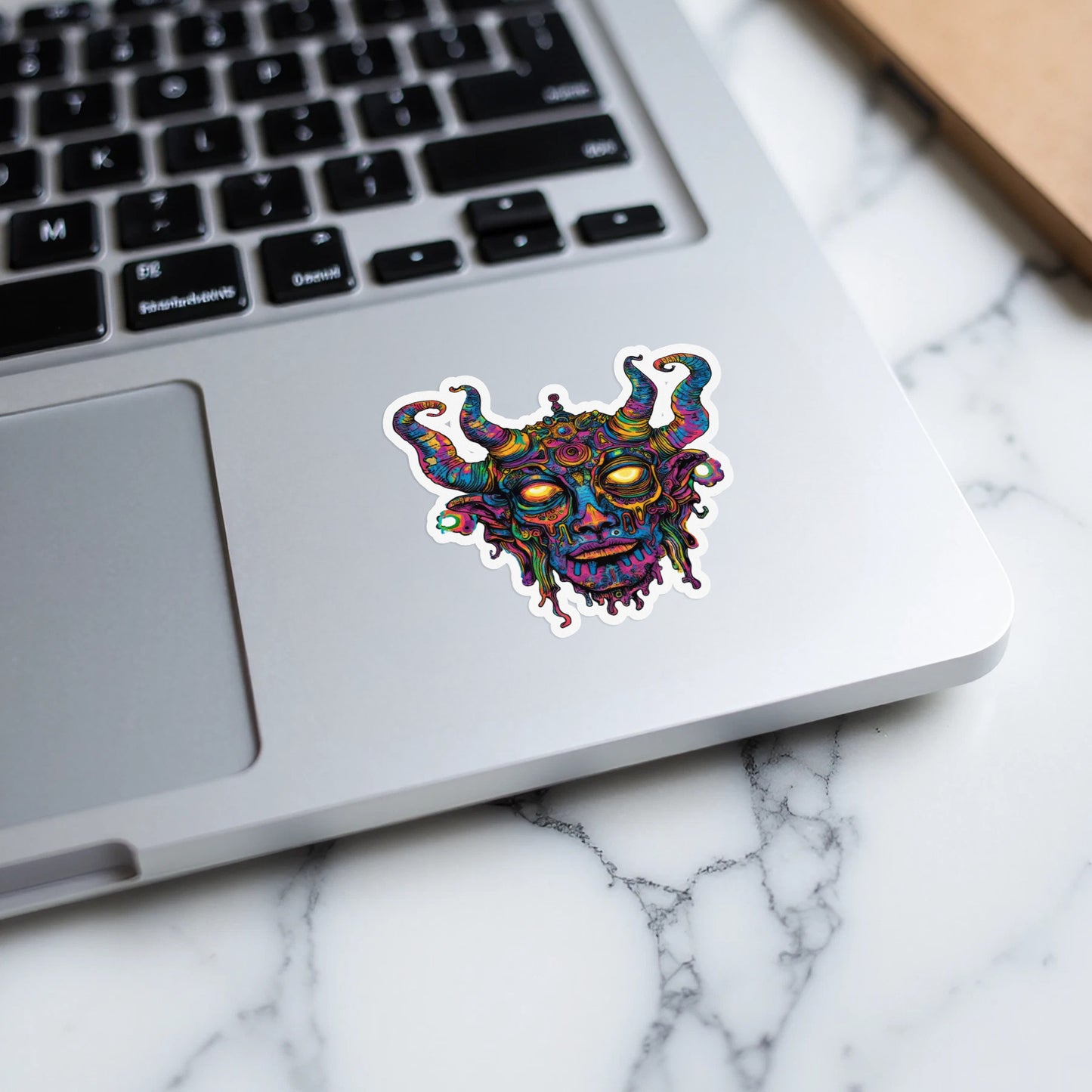 Psychedelic demon face sticker with swirling horns and melting colorful features.