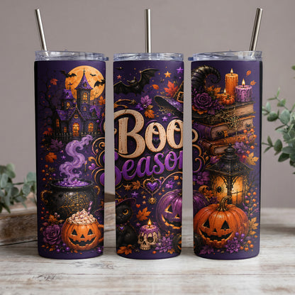 Three purple tumblers with Halloween designs including pumpkins, a haunted house, and "Boo Season" text.