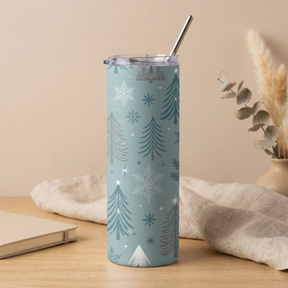 Blue tumbler with white and gray Christmas tree and snowflake pattern and metal straw.