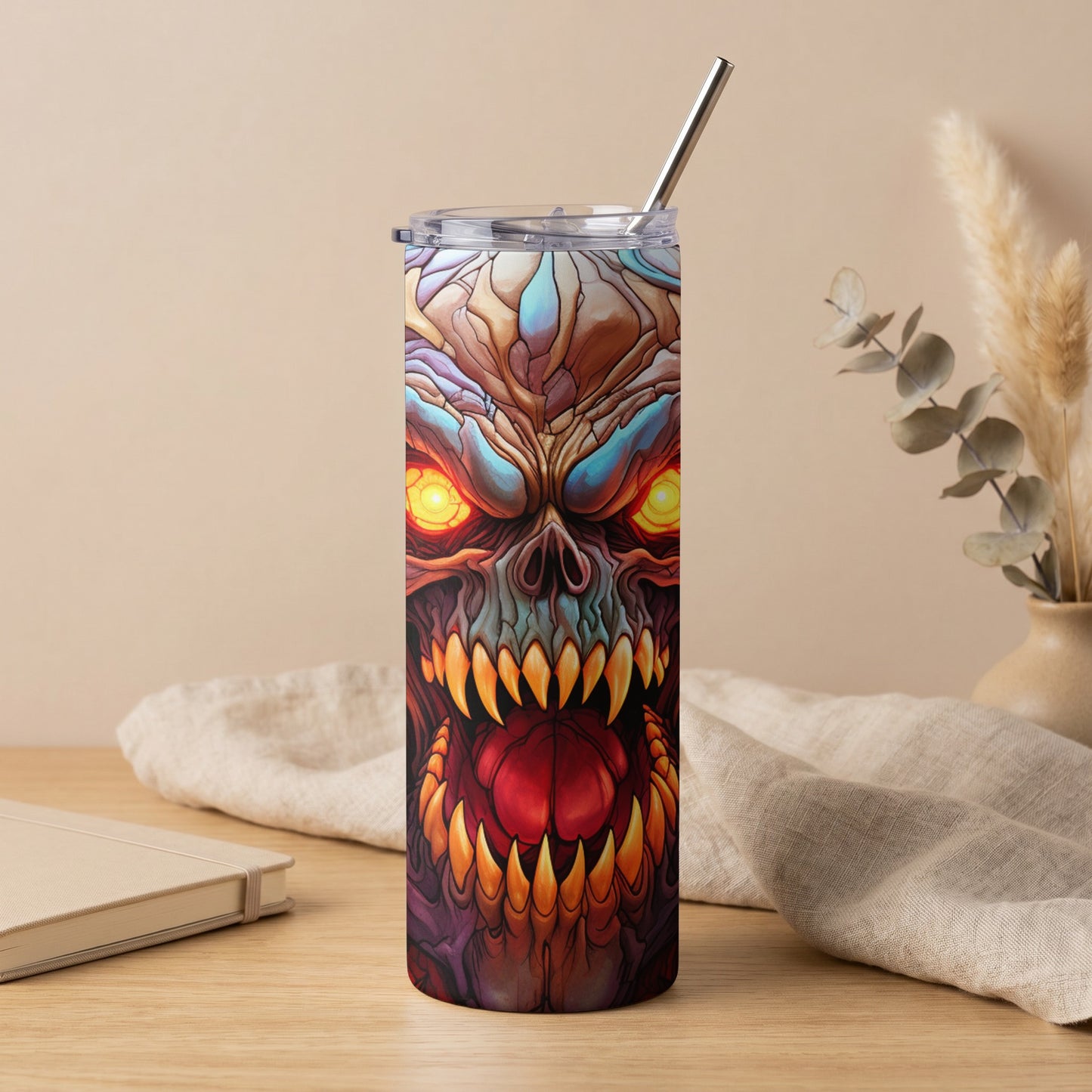 Tumbler with a detailed, monstrous face design in vibrant colors.