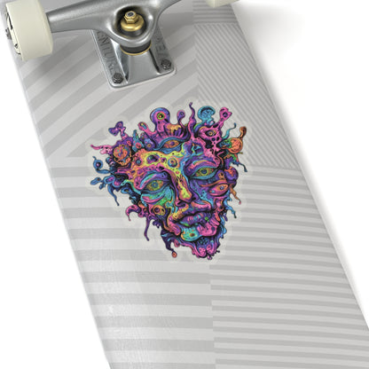 Colorful psychedelic face sticker on a skateboard deck with grey striped grip tape.