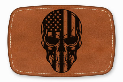 Brown leather patch with rounded corners featuring a black engraved American flag skull graphic.