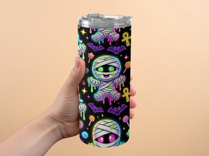 Tumbler with black background, cartoon mummies, bats, lollipops, and stars pattern.